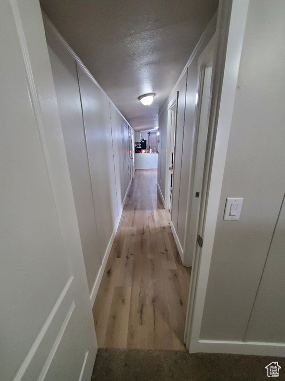 Hall with light hardwood / wood-style flooring