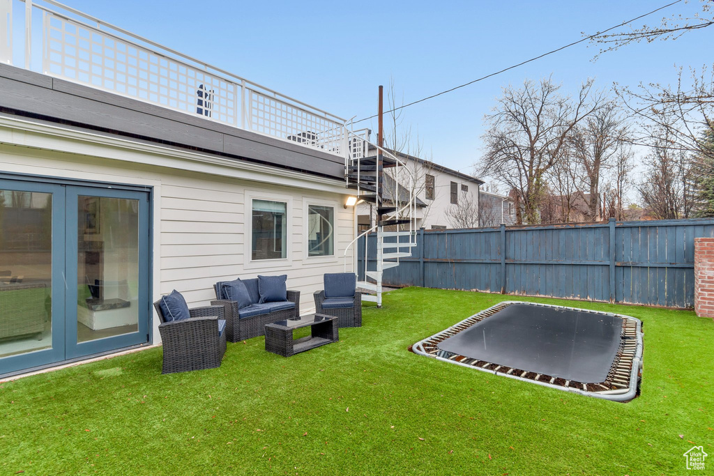 View of yard featuring an outdoor hangout area and a trampoline