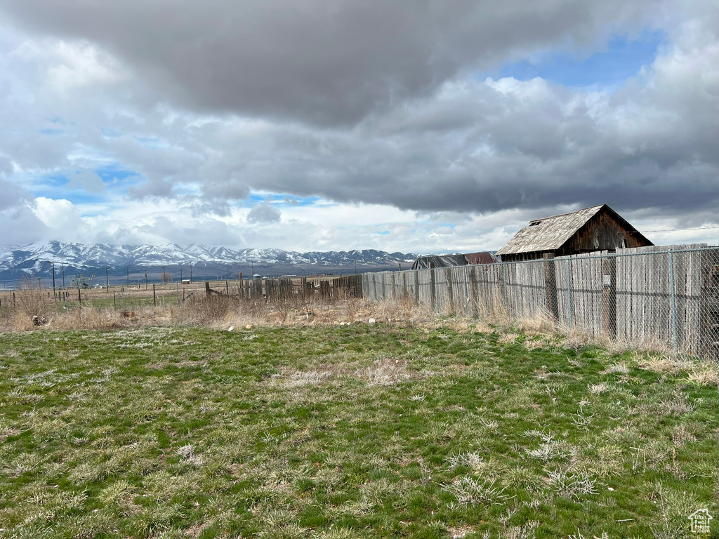 View of yard with a mountain view and a rural view