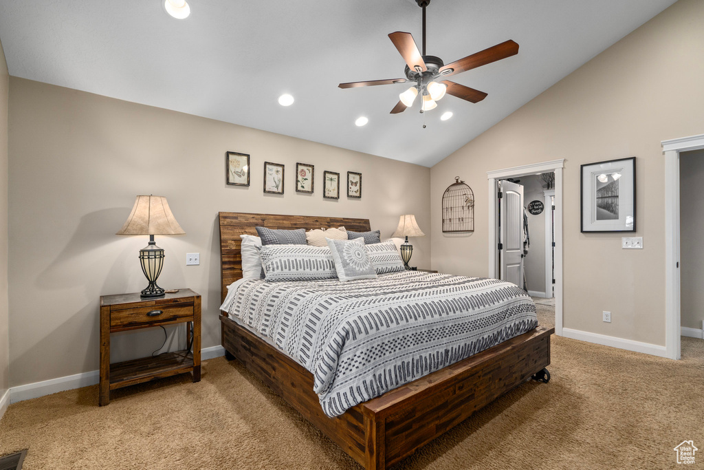 Bedroom with lofted ceiling, light carpet, and ceiling fan