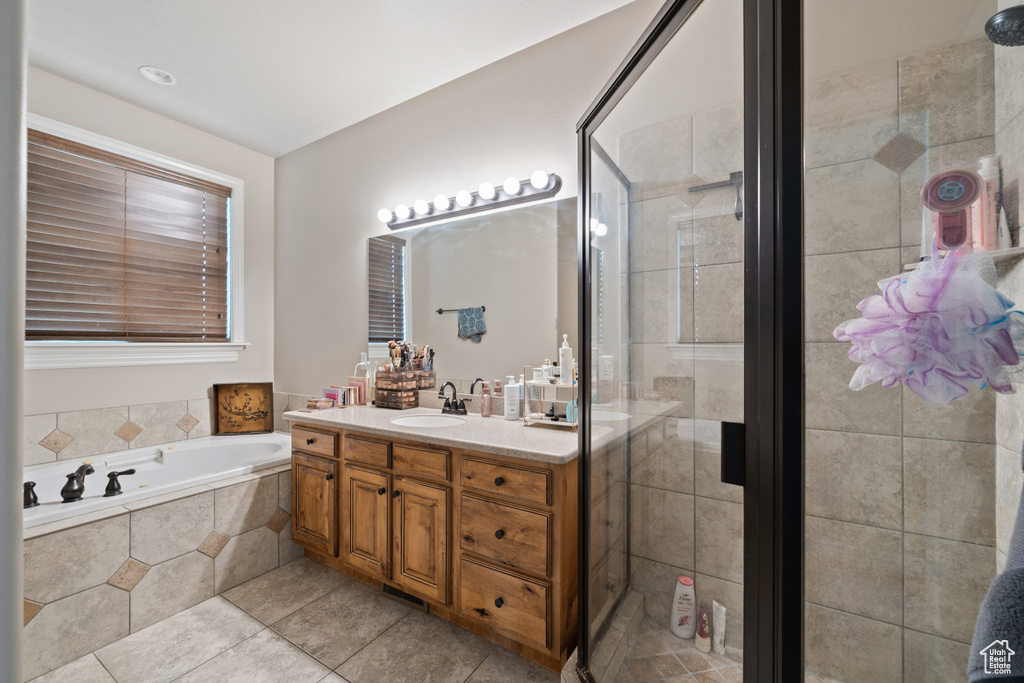 Bathroom with tile floors, separate shower and tub, and large vanity