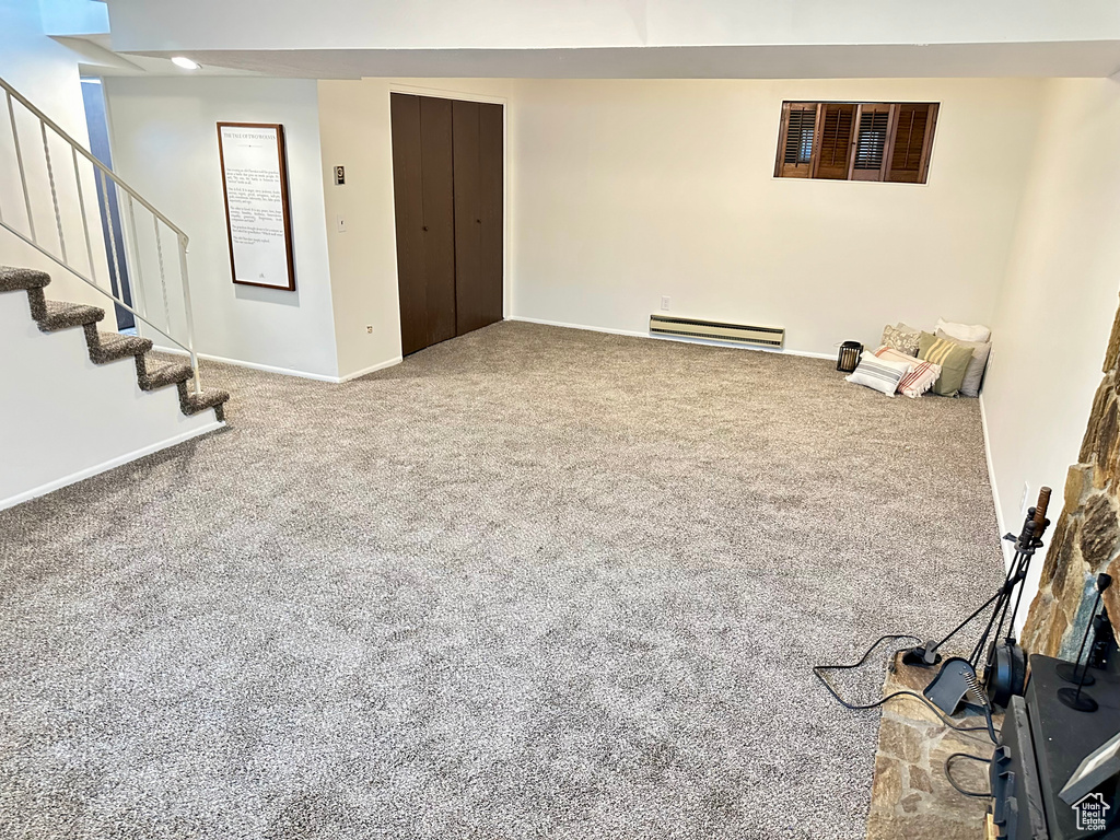 Interior space with light carpet and baseboard heating