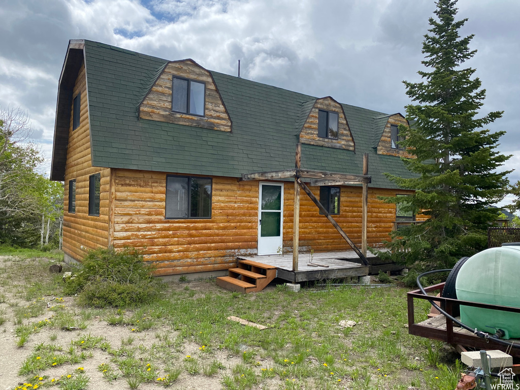 Rear view of property featuring a deck