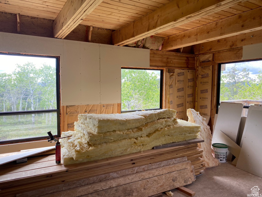 Interior space featuring wood ceiling, beam ceiling, and multiple windows