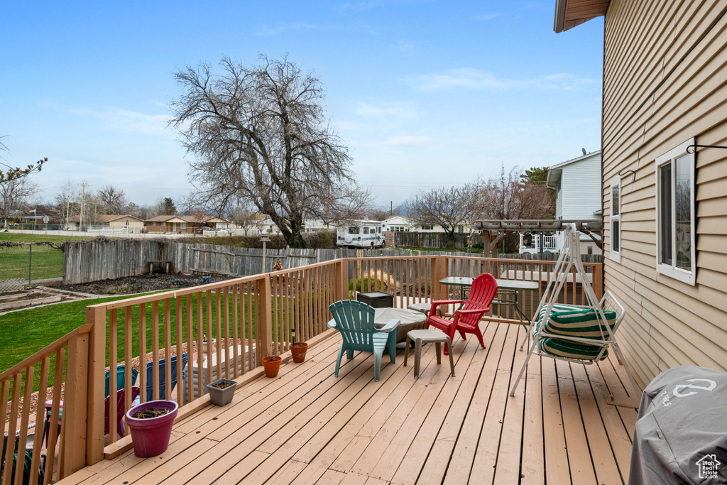 Wooden deck featuring grilling area and a yard