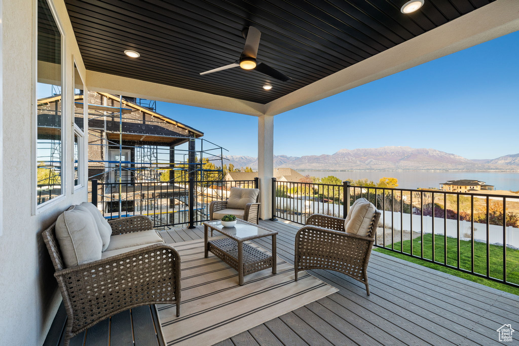 Deck featuring a mountain view, an outdoor hangout area, and ceiling fan