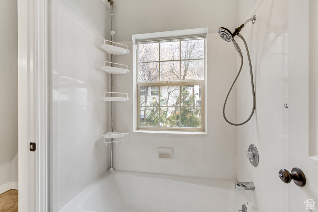 Bathroom featuring shower / washtub combination and a wealth of natural light