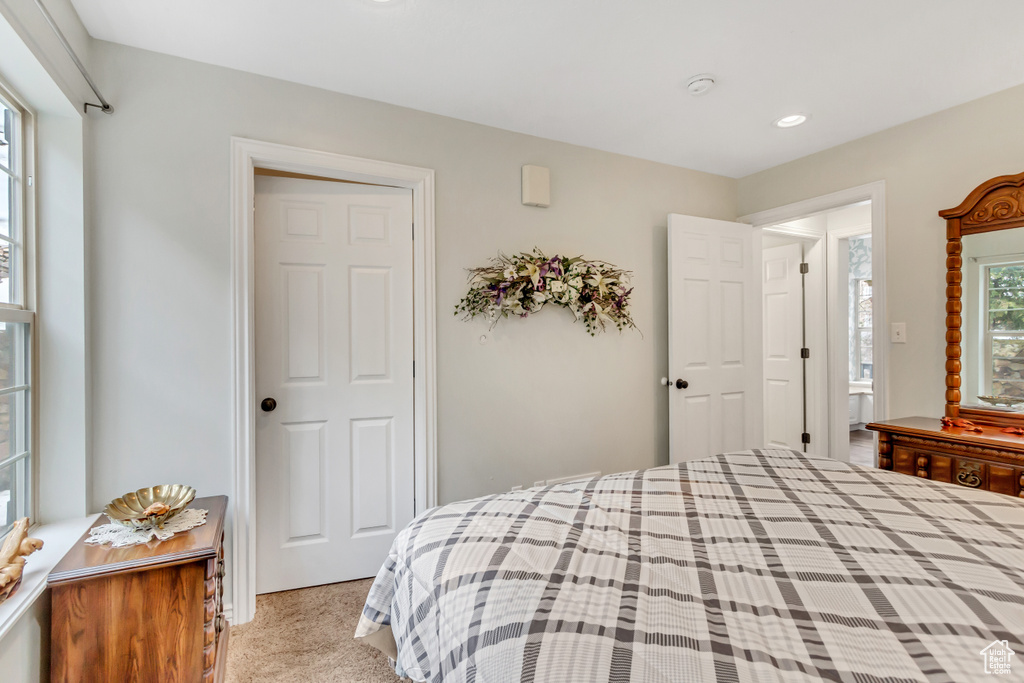 Bedroom featuring light colored carpet and a closet
