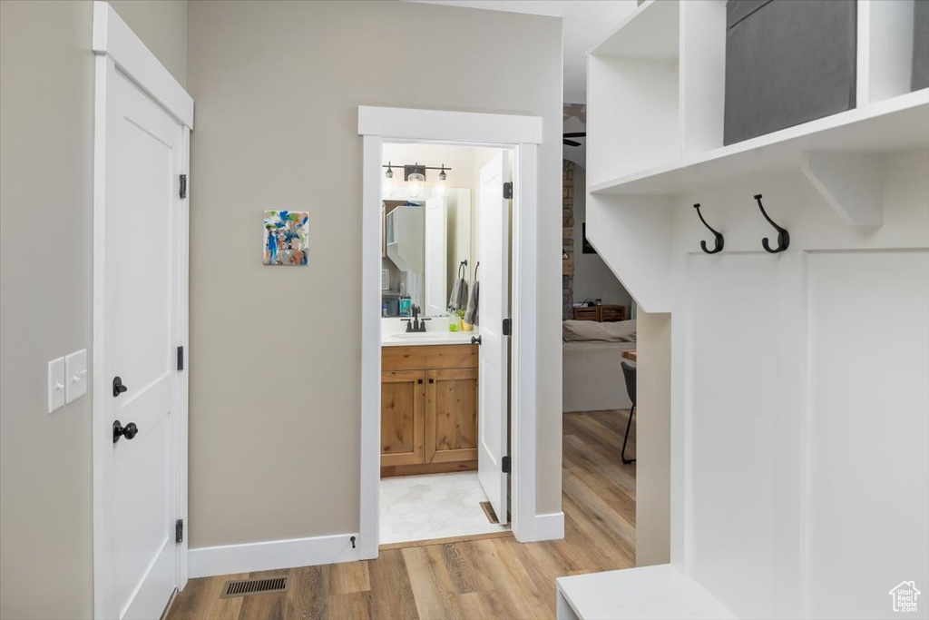 Mudroom with sink and light tile floors
