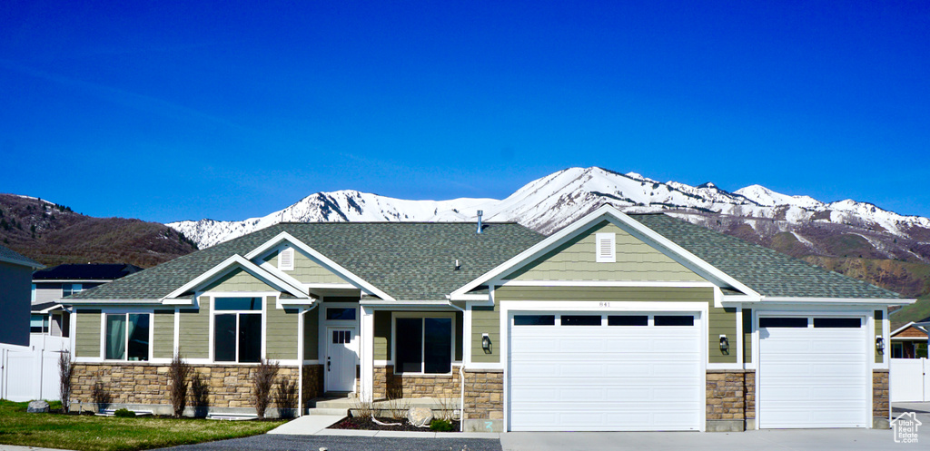 Craftsman inspired home with a mountain view and a garage