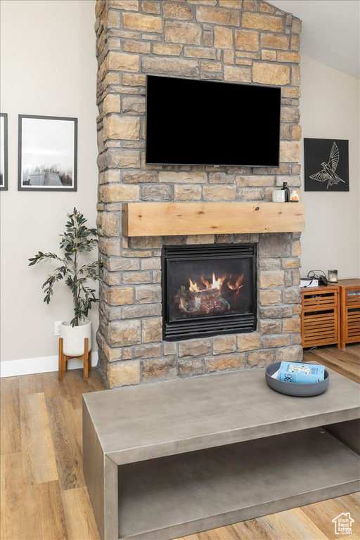 Interior details featuring a stone fireplace and light hardwood / wood-style flooring