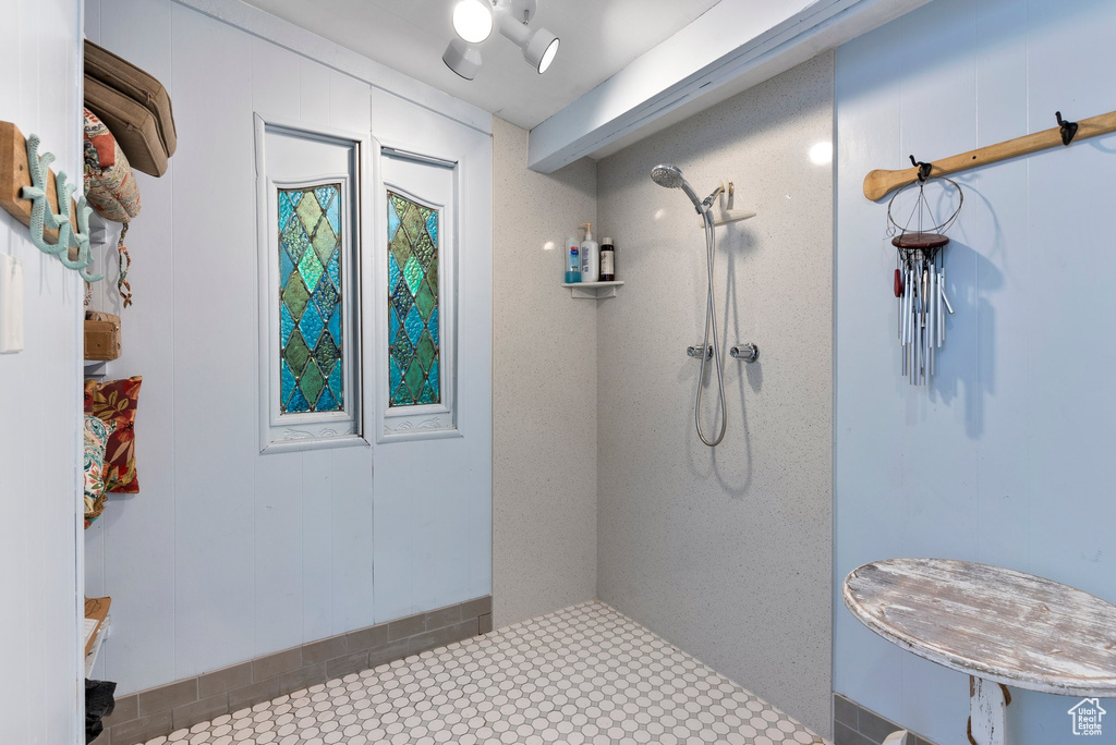 Bathroom with a shower and tile floors