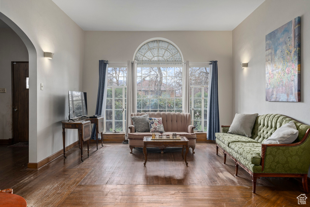 Sitting room featuring plenty of natural light and dark hardwood / wood-style floors