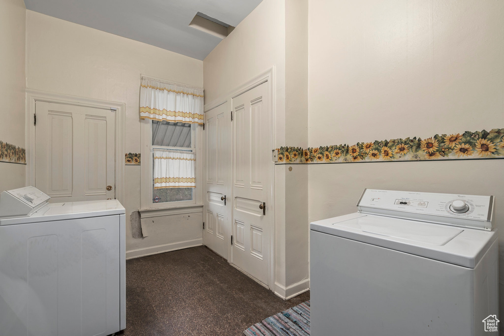 Washroom with dark colored carpet and washing machine and clothes dryer