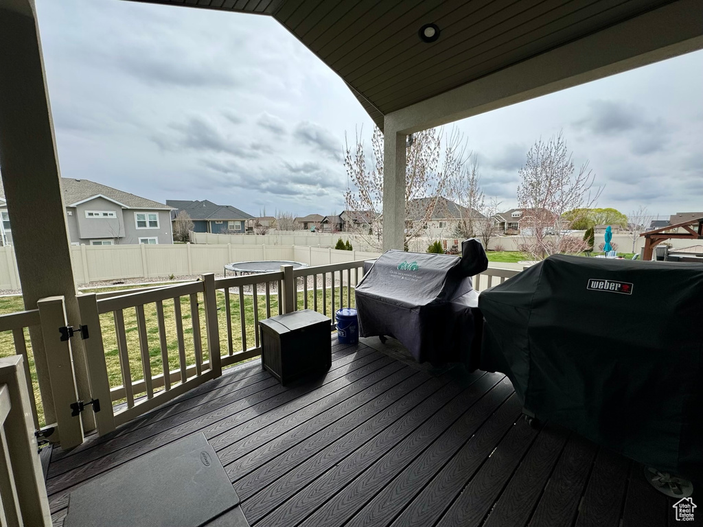 Deck with a lawn and area for grilling
