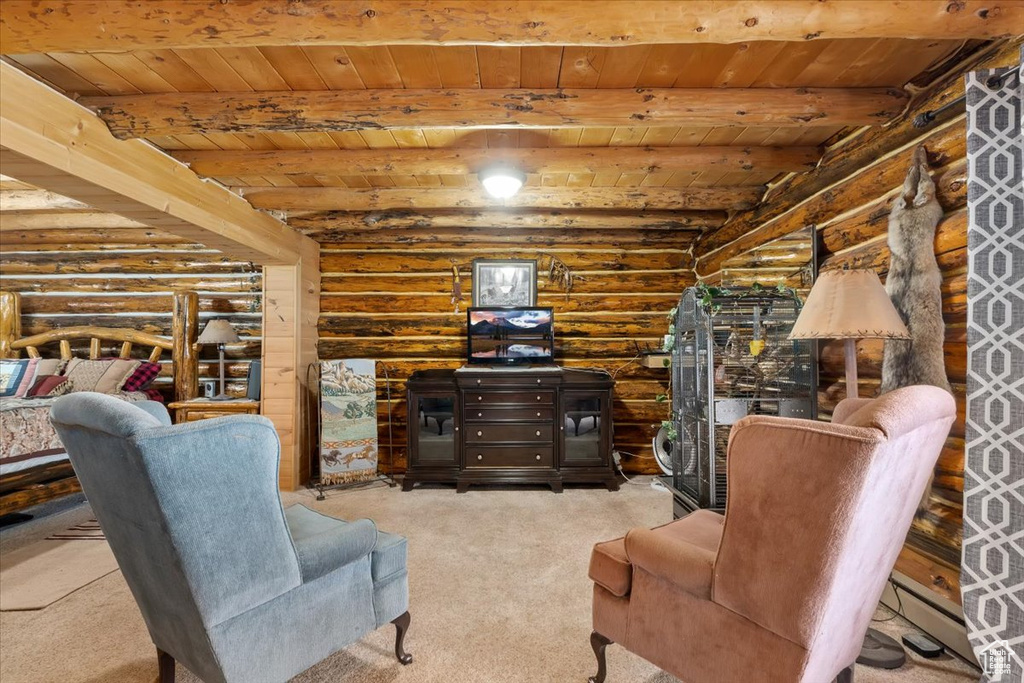 Carpeted living room featuring log walls, wooden ceiling, and beamed ceiling