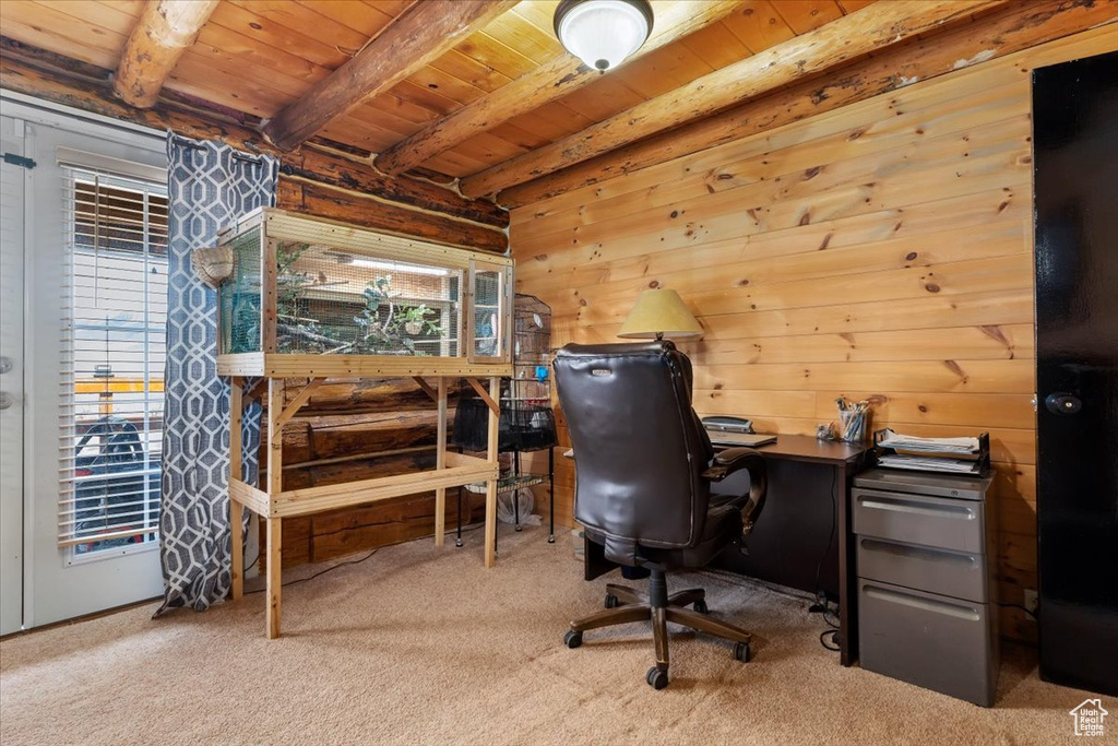 Carpeted home office with wood walls, wood ceiling, and beamed ceiling