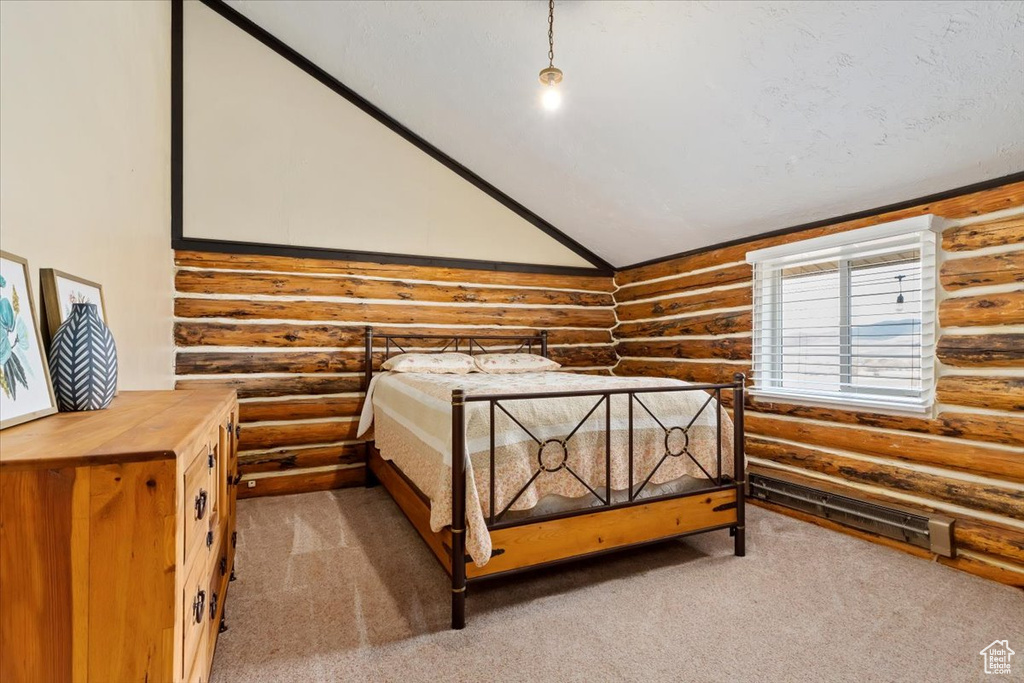 Carpeted bedroom with rustic walls and lofted ceiling