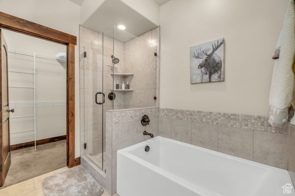 Bathroom featuring tile flooring and independent shower and bath