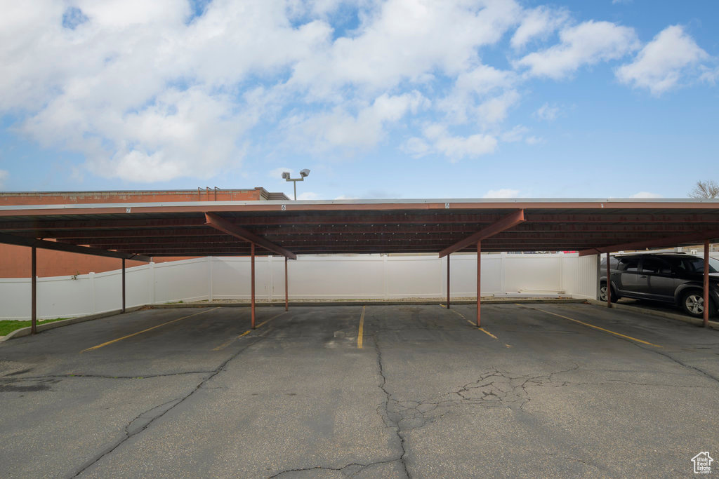 View of parking / parking lot with a carport