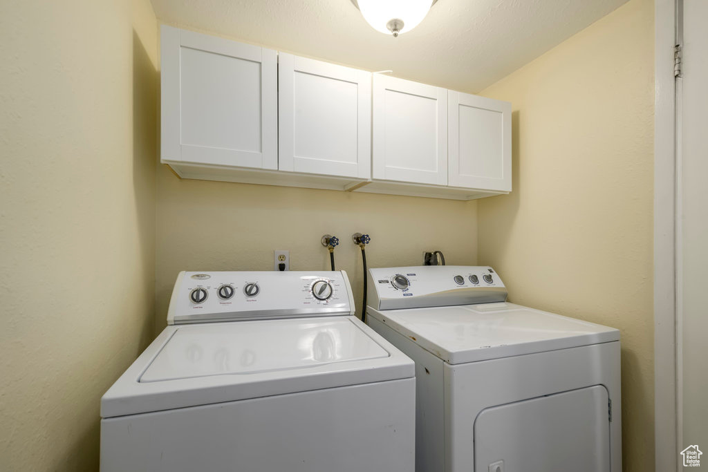 Laundry room with washer and dryer, washer hookup, and cabinets