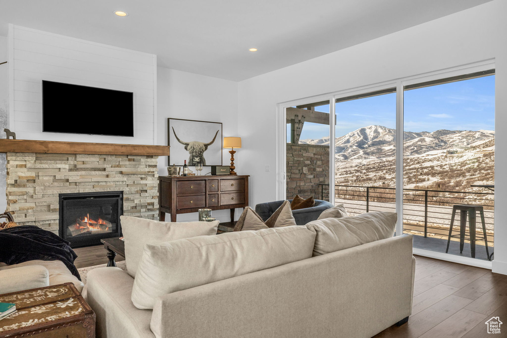 Living room with a fireplace, a mountain view, and dark hardwood / wood-style flooring