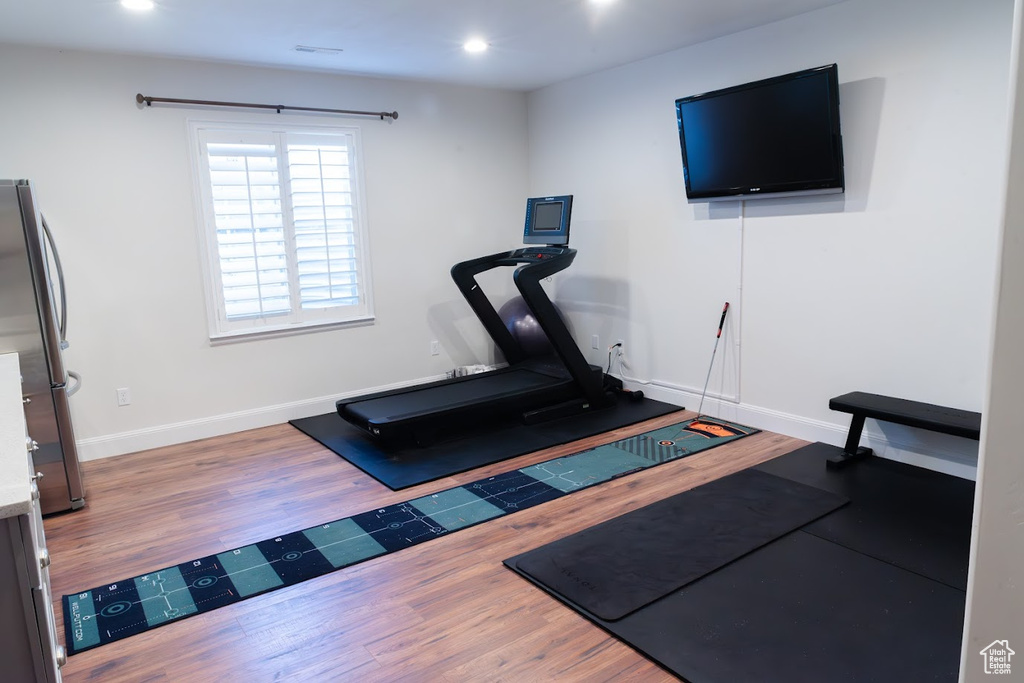 Exercise area featuring hardwood / wood-style floors