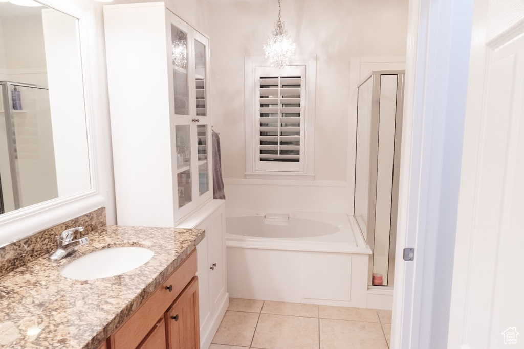 Bathroom with shower with separate bathtub, tile flooring, and vanity