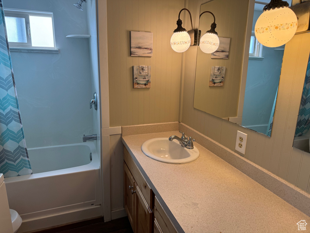 Full bathroom with shower / tub combo, large vanity, and toilet