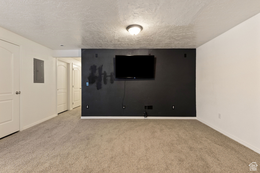 Spare room featuring a textured ceiling and light colored carpet
