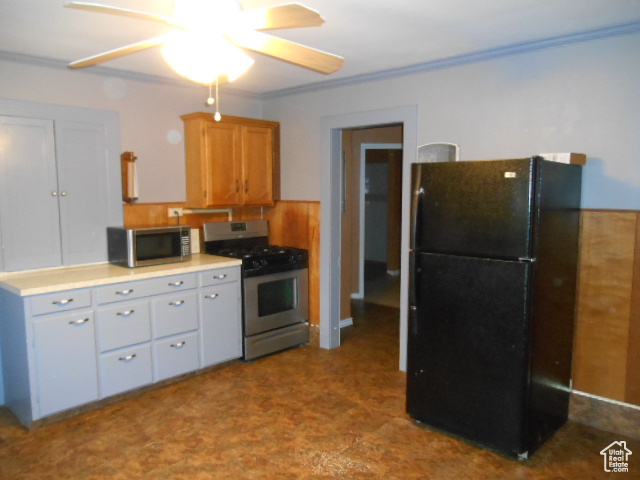 Kitchen featuring gas stove, black refrigerator, and ceiling fan