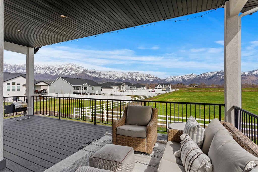 Wooden terrace with a lawn, an outdoor hangout area, and a mountain view