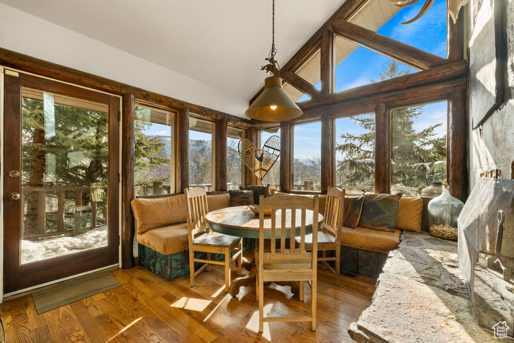 Sunroom / solarium featuring plenty of natural light and vaulted ceiling with beams