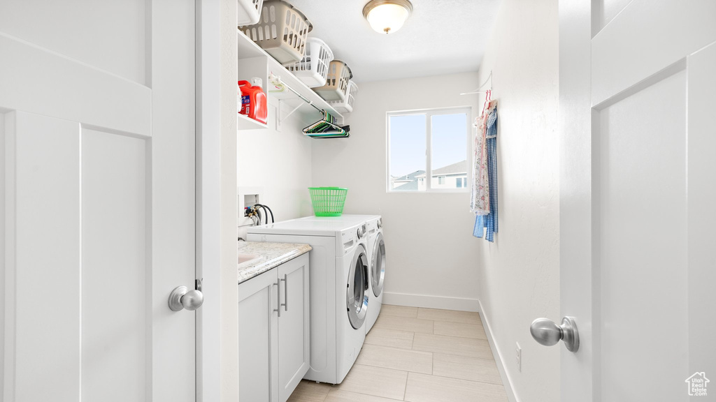 Laundry room with light tile floors, cabinets, separate washer and dryer, and hookup for a washing machine