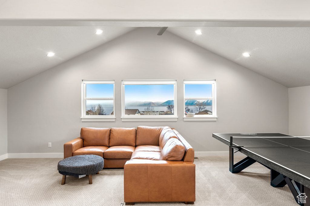 Game room with light colored carpet, vaulted ceiling with beams, and a wealth of natural light