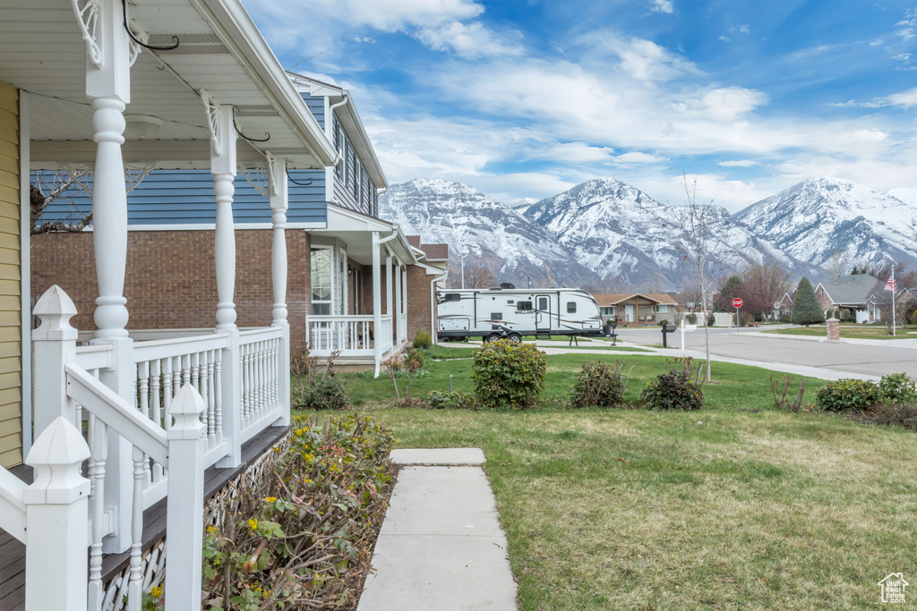 View of yard featuring a mountain view and covered porch