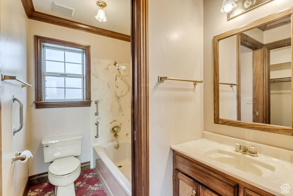 Full bathroom with toilet, ornamental molding, large vanity, and bathtub / shower combination