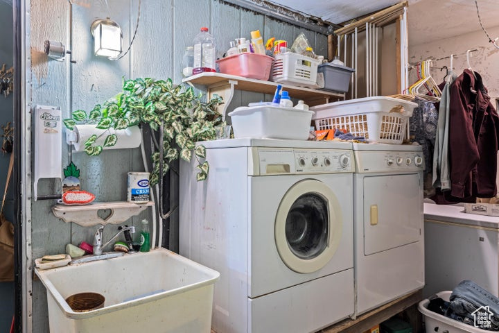 Laundry area featuring washing machine and dryer and sink