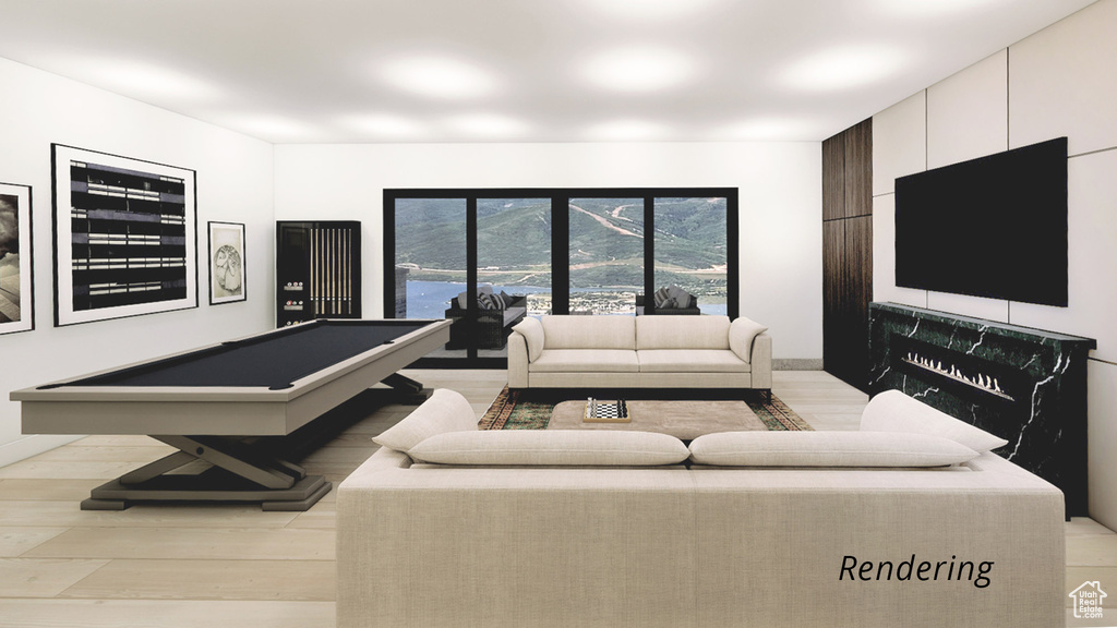 Living room featuring pool table and light hardwood / wood-style floors