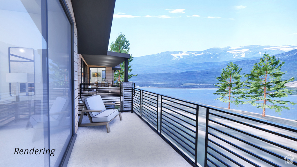 Balcony featuring a water and mountain view