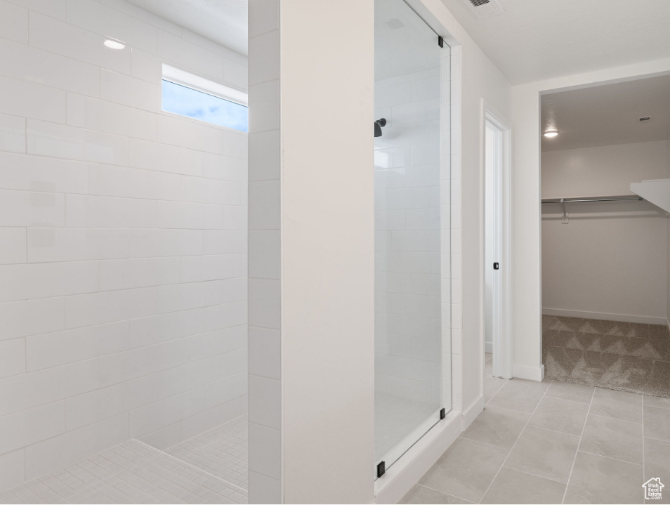 Bathroom with tile floors and a tile shower