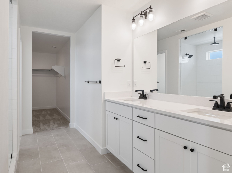 Bathroom with oversized vanity, double sink, and tile flooring