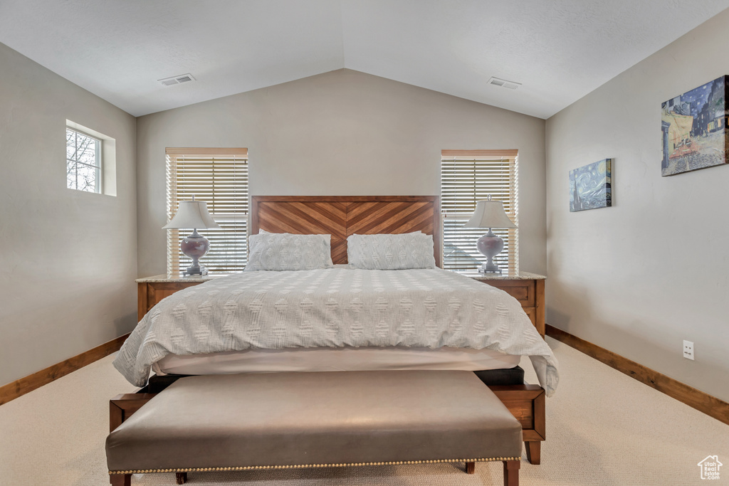 Bedroom featuring lofted ceiling and carpet floors