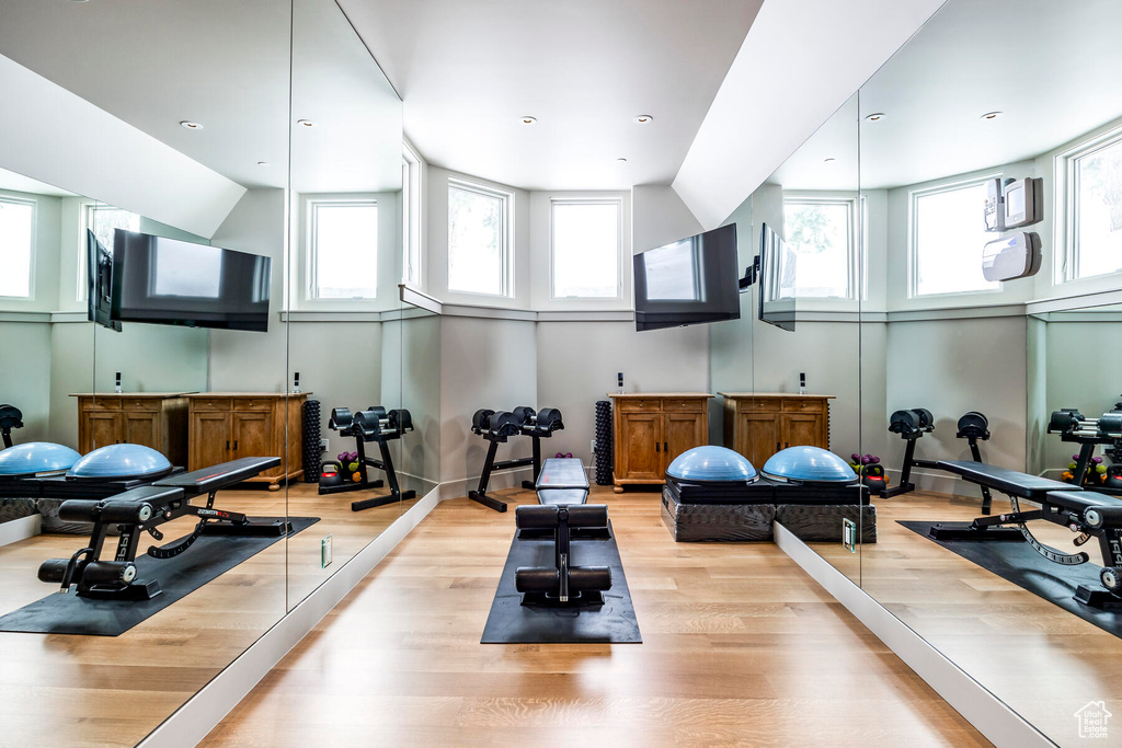 Workout room featuring light wood-type flooring