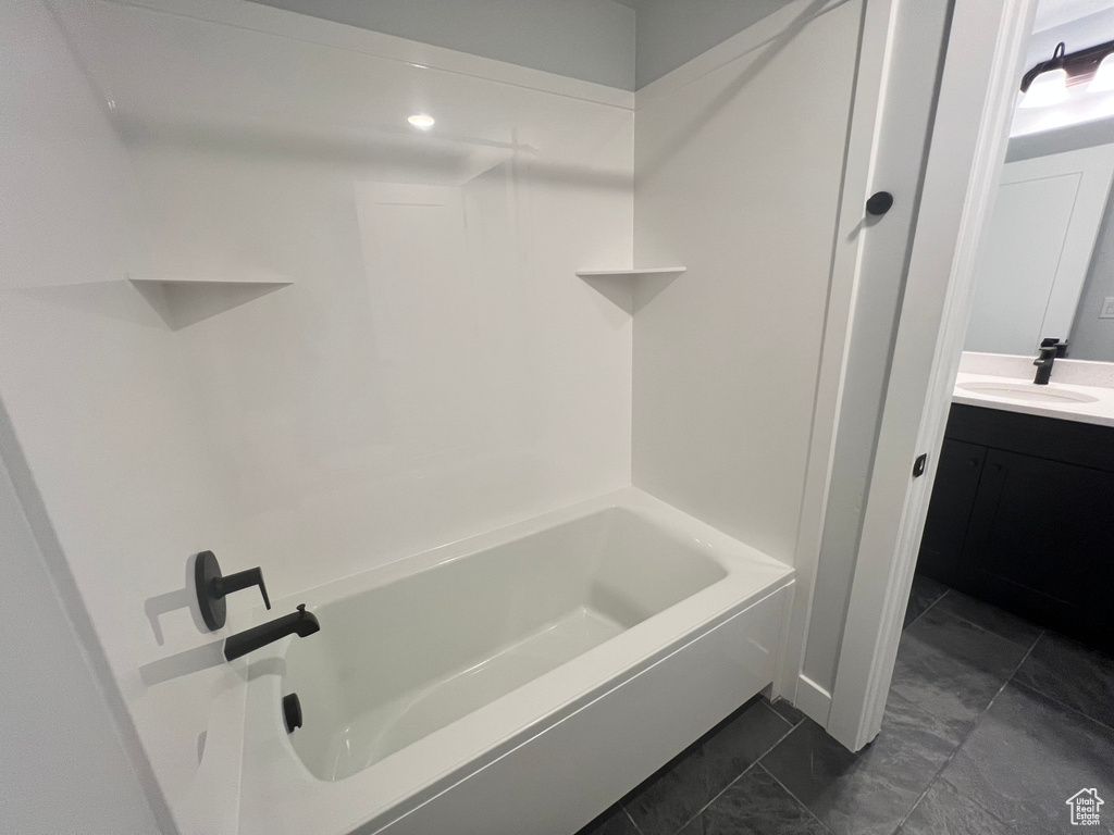 Bathroom featuring tile floors, shower / bath combination, and vanity
