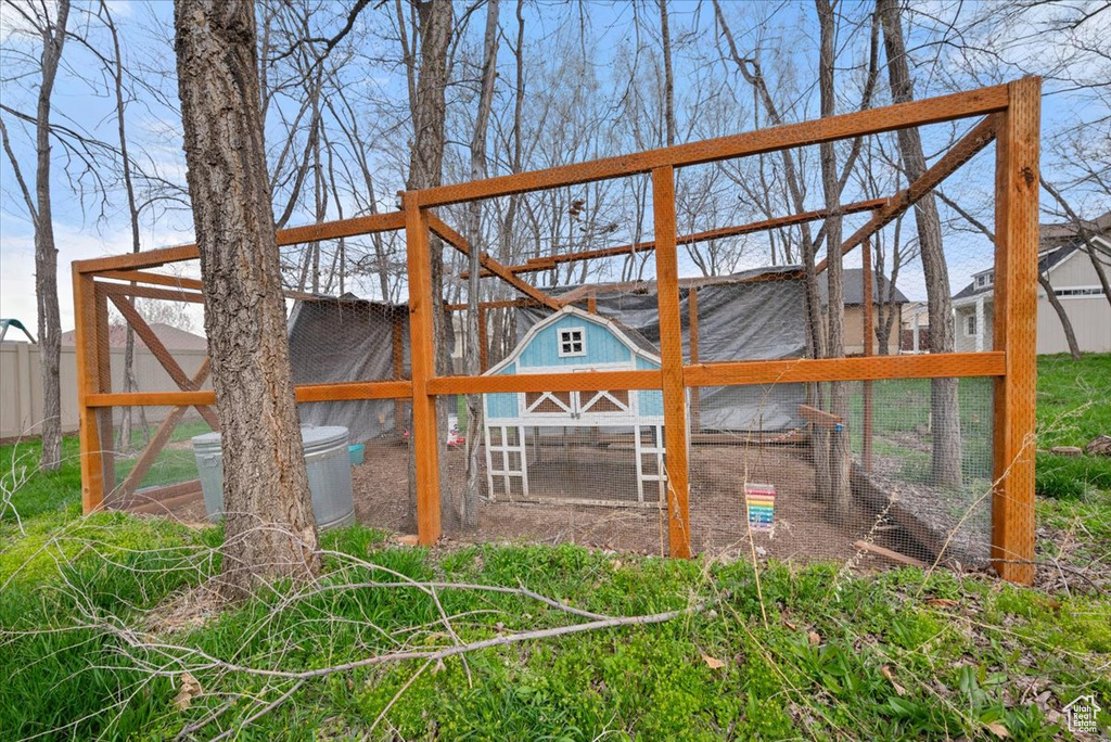 Back of property featuring an outdoor structure