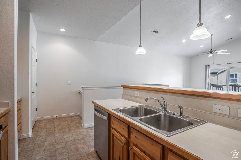 Kitchen featuring pendant lighting, ceiling fan, stainless steel dishwasher, and sink