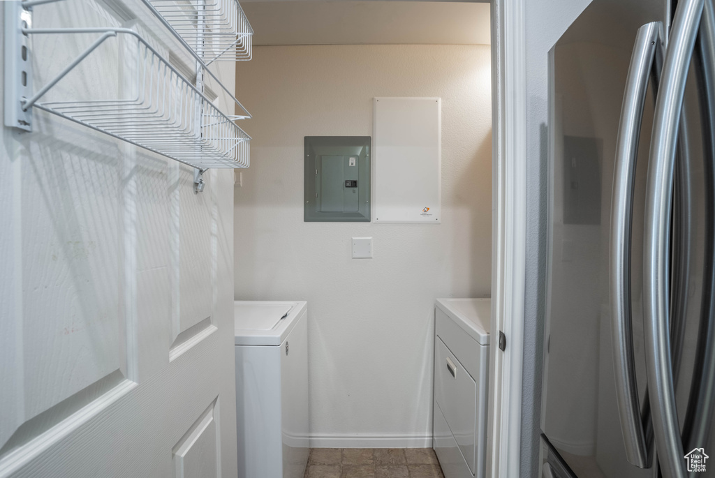 Washroom with separate washer and dryer and light tile floors