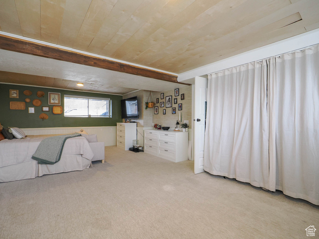 Unfurnished bedroom featuring wooden ceiling and light colored carpet