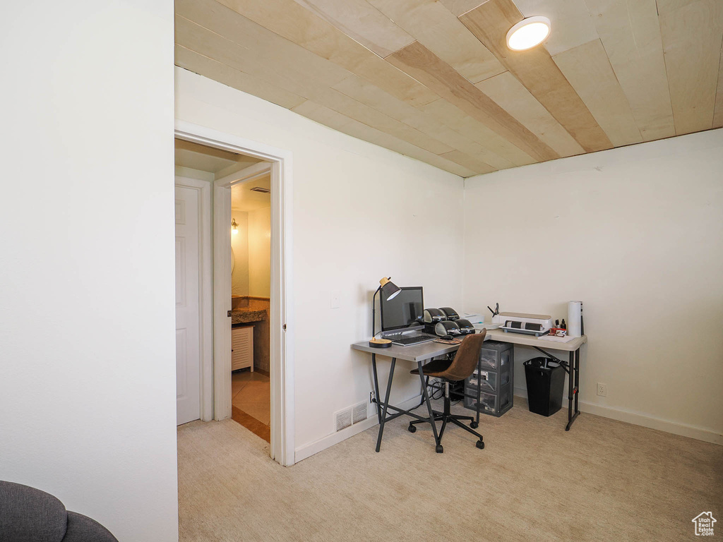 Carpeted home office featuring wood ceiling